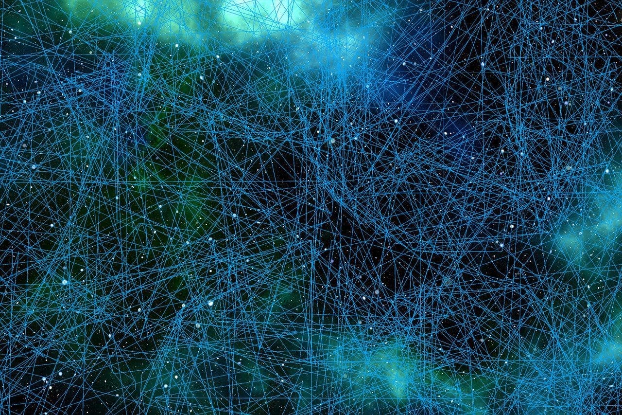 Intricate network of glowing blue and green lines and dots against a dark background